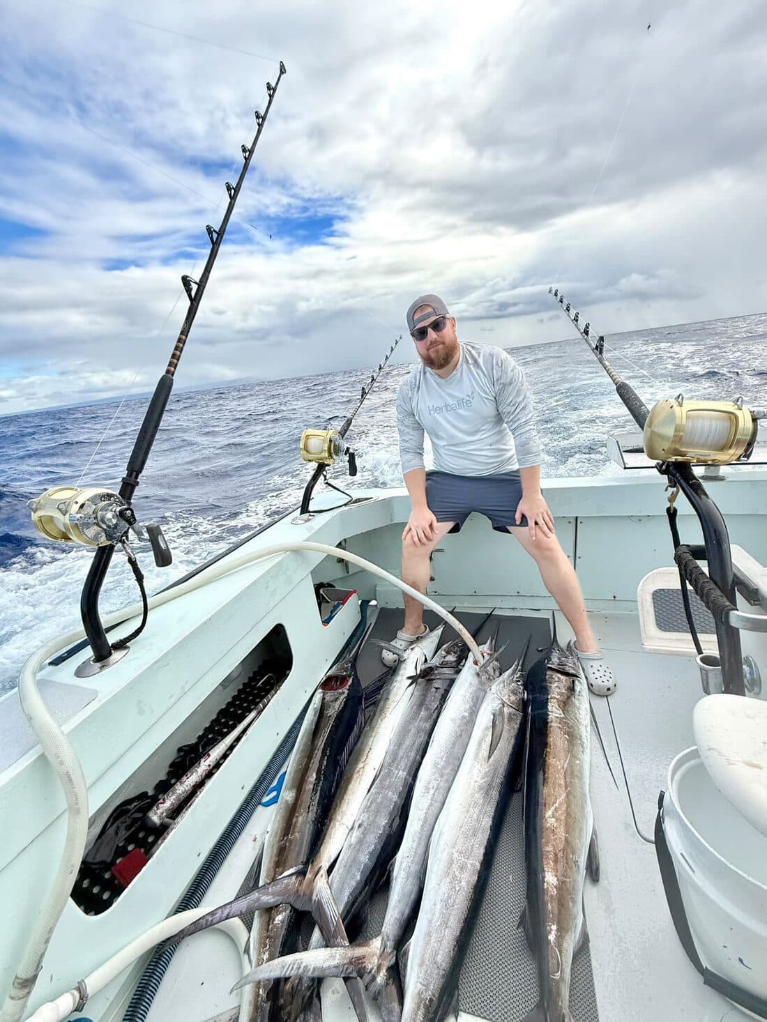 An angler sitting behind a deck full of ono