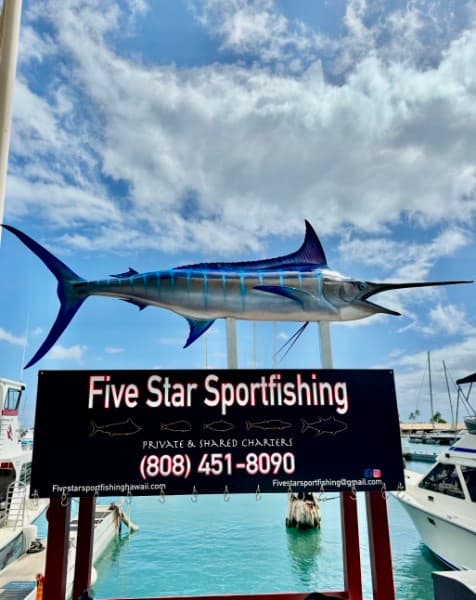 The Five Star Sportfishing sign with a blue marlin mounted above it at Slip F9